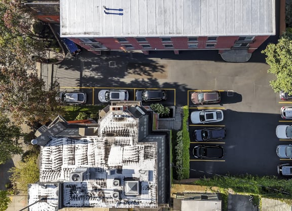 an aerial view of a building with cars parked in a parking lot at The Granite Works Apartments , New York