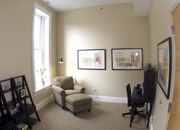 an office with a chair and a desk and a window at The Granite Works Apartments , Buffalo