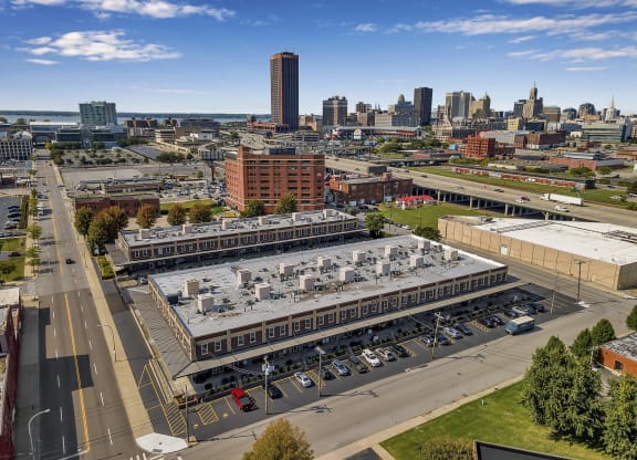 an aerial view of a large building with a city in the background at The Lofts at Elk Terminal, Buffalo, New York