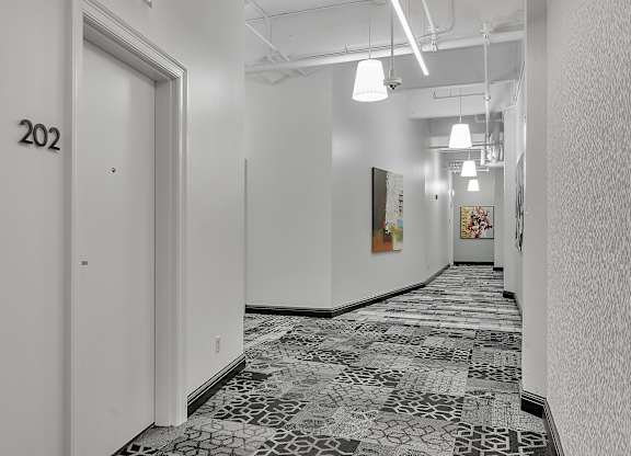 a view of a hallway with white walls and a tile floor at 100 South Apartments, New York
