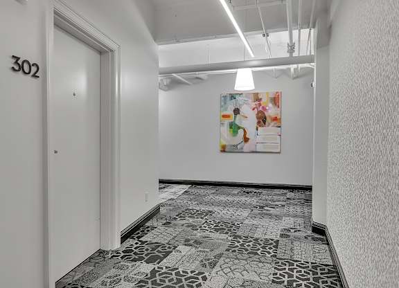 a room with a door and a painting on the wall at 100 South Apartments, Buffalo