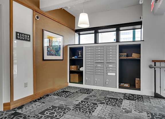 a lockers room in a hallway with a staircase and windows at 100 South Apartments, New York
