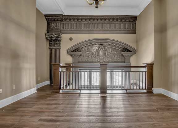 a living room with a fireplace and a wooden floor at The Knights @ 506 Delaware Apartments, Buffalo, 14202