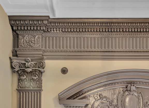 A balcony with a railing and a column with a decorative capital. at The Knights @ 506 Delaware Apartments, Buffalo, New York