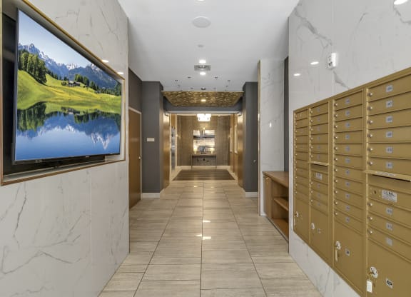 a view of a hallway with mailboxes and a television on the wall at Nineteen North, New York, 14202