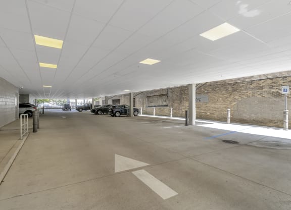 a parking garage with cars and a brick wall at Nineteen North, Buffalo, NY
