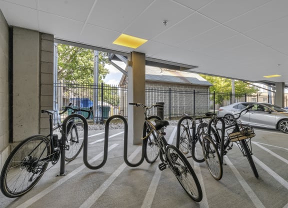 a row of bikes parked inside of a parking garage at Nineteen North, Buffalo, 14202
