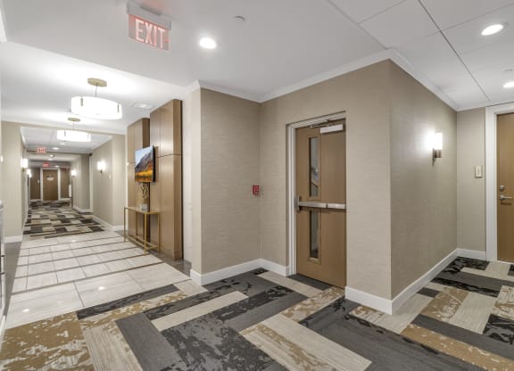 a hallway with elevators and doors in a building at Nineteen North, Buffalo