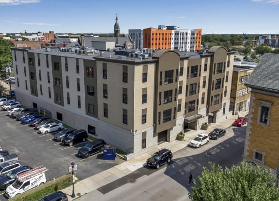 an aerial view of an apartment building with a parking lot and cars parked at Nineteen North, New York, 14202