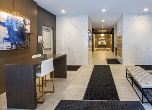 a long hallway with tables and chairs and marble walls and floors at Nineteen North, Buffalo, NY, 14202