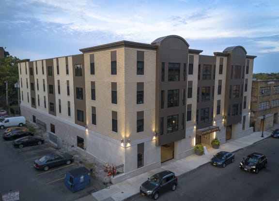 a large apartment building with cars parked in front of it at Nineteen North, Buffalo, New York