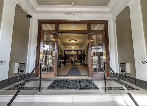 a view of the entrance to the lobby of a building with glass doors at The Knights @ 506 Delaware Apartments, Buffalo, NY 14202