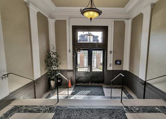 a lobby with stairs and a glass door at The Knights @ 506 Delaware Apartments, New York, 14202