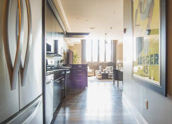 a view of a kitchen and a living room from a hallway at The Knights @ 506 Delaware Apartments, Buffalo, NY