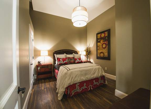a bedroom with a bed and two nightstands at The Knights @ 506 Delaware Apartments, New York