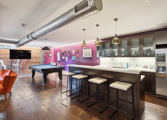A modern kitchen with a pool table and bar stools. at Walnut on Highland, Pittsburgh, PA