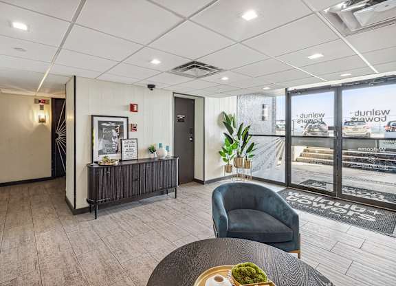 A modern office lobby with a reception desk and a chair at Walnut Towers at Frick Park, Pittsburgh, Pennsylvania