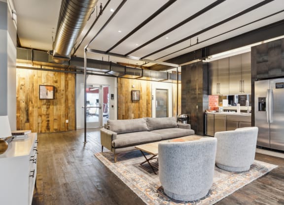 a living room with a couch and chairs and a kitchen at Bakery Living, Pittsburgh, PA
