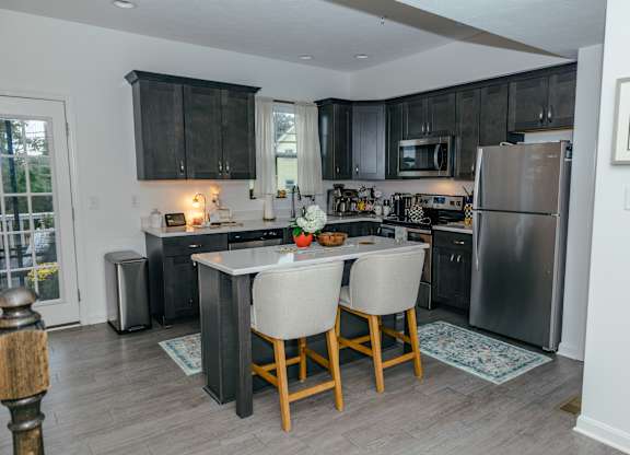 A kitchen with a table and chairs in the middle of it. at Highland Village, Ross Township, Pittsburgh, PA 15229