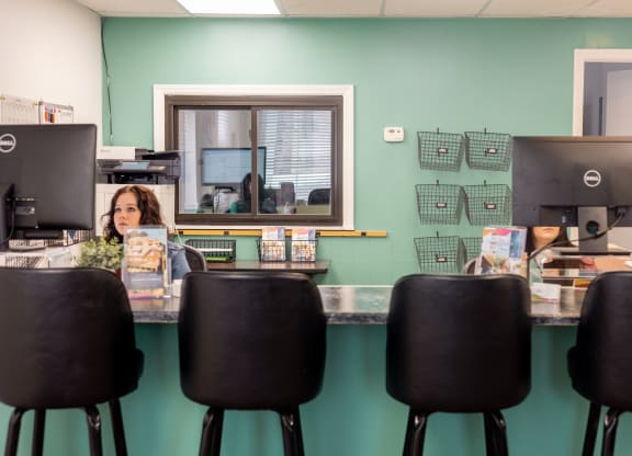 a woman sitting at a desk in front of a computer at University Commons Apartments, Oakland, Pittsburgh