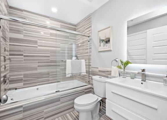 a bathroom with a white toilet next to a bathtub at The Washington at Chatham, Pittsburgh, 15219