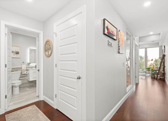 a hallway with a white door and hardwood floors at The Washington at Chatham, Pennsylvania, 15219