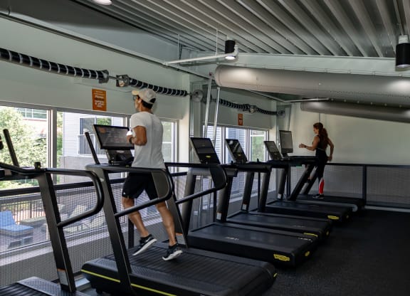 a man and a woman running on treadmills in a gym at Bakery Living in Pittsburgh, PA 15206
