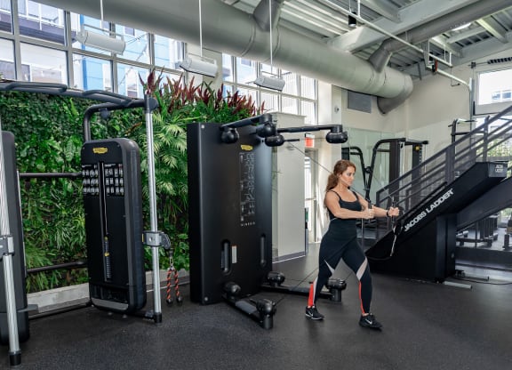 a woman is running on a treadmill in a gym at Bakery Living in Pittsburgh, PA 15206