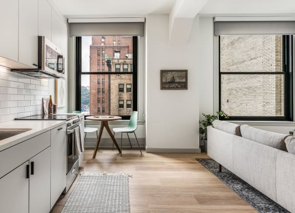 a kitchen with white cabinets and a sink and a window at The Commonwealth Building, Pittsburgh