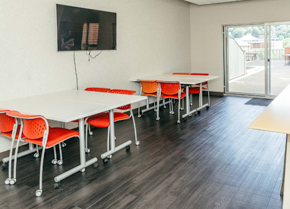 A conference room with a long table and chairs.