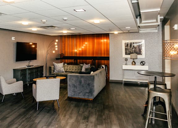 A living room with a couch, chair, and television.