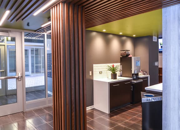 a view from the kitchen into the reception area with a wood column in the foreground at Walnut on Highland, Pittsburgh, PA
