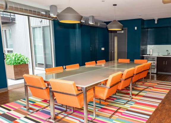 a conference room with a long table and orange chairs at Walnut on Highland, Pittsburgh, PA