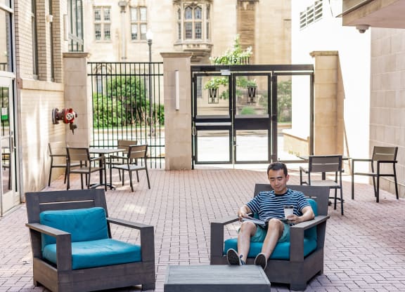 a man sitting in a chair on a patio at Walnut on Highland, Pittsburgh, PA