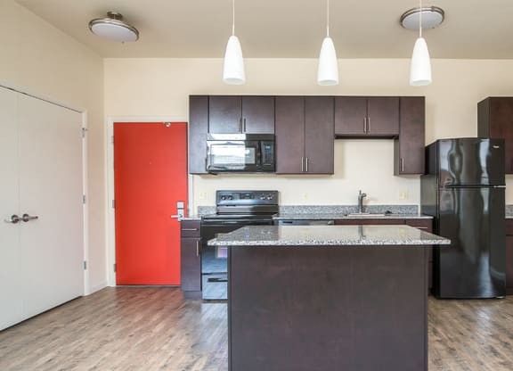 a kitchen with a black refrigerator freezer and a black stove top oven at Walnut on Highland, Pittsburgh, PA