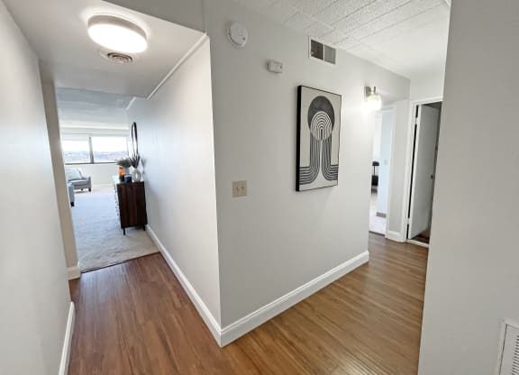 a view of the hallway of an apartment with hardwood floors at Walnut Towers at Frick Park, Pittsburgh, 15217