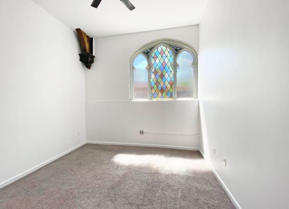 Carpeted Bedroom with Unique Window at University Commons, Pittsburgh 15213