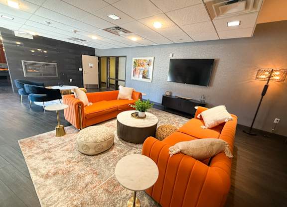 A living room with a fireplace and a television. Hot Metal Flats apartments, Southside Pittsburgh, PA