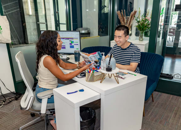 a man and a woman sitting at a desk in front of a computer at Walnut on Highland, Pennsylvania 15206