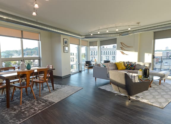 an open living room and dining room with a view of the city at Walnut on Highland, Pittsburgh, PA
