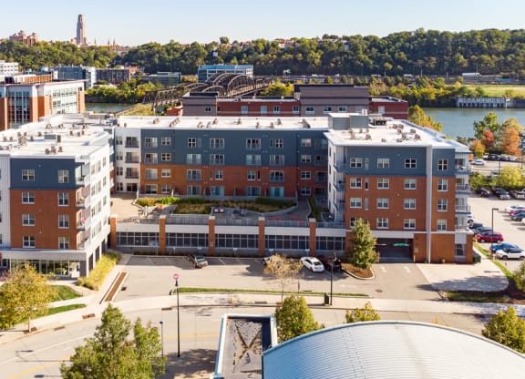 an aerial view of an apartment complex with a river in the background Hot Metal Flats apartments, Southside Pittsburgh, PA