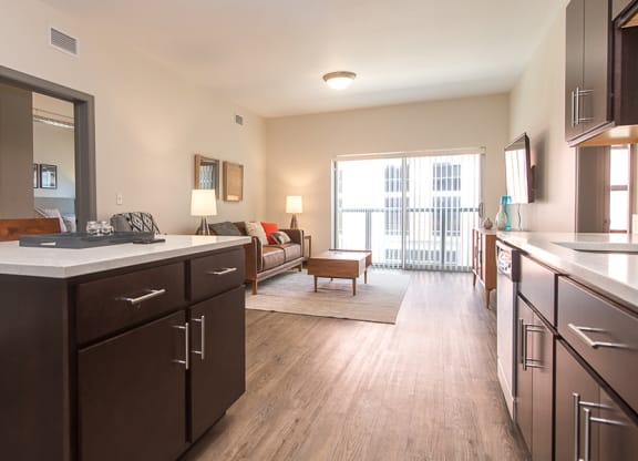 a kitchen and living room with a sliding glass door to a balcony Hot Metal Flats apartments, Southside Pittsburgh, PA