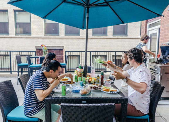 a group of people sitting around a table eating food at Walnut on Highland, Pittsburgh, PA