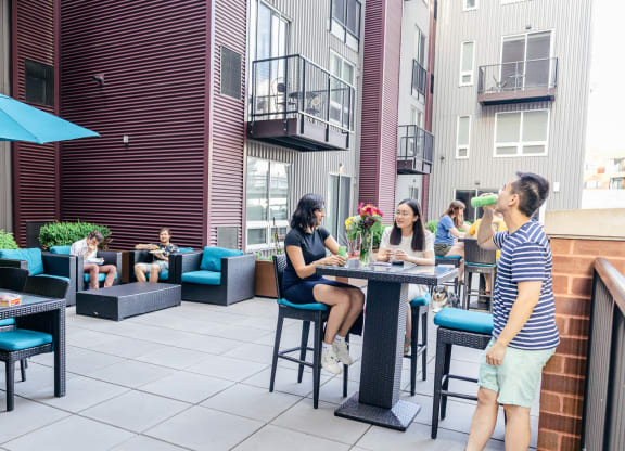 a group of people sitting at a table on a patio at Walnut on Highland, Pittsburgh, PA