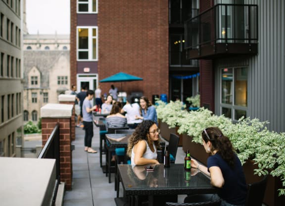 people sitting at tables on a patio in front of a brick building at Walnut on Highland, Pittsburgh, PA