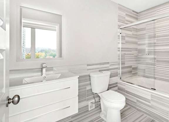 A white bathroom with a toilet, sink, and shower. at The Washington at Chatham, Pennsylvania, 15219