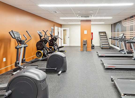 A gym with treadmills, elliptical machines, and stationary bikes. at The Washington at Chatham, Pennsylvania, 15219
