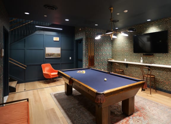 a game room with a pool table and a tv at The Commonwealth Building, Pittsburgh, 15222