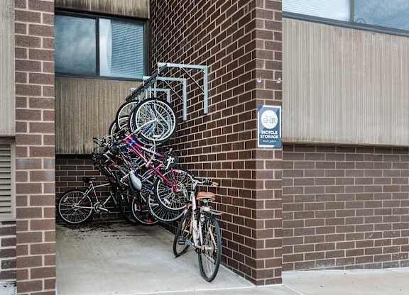 A bunch of bicycles are parked on a bike rack at Walnut Towers at Frick Park, Pittsburgh, PA 15217
