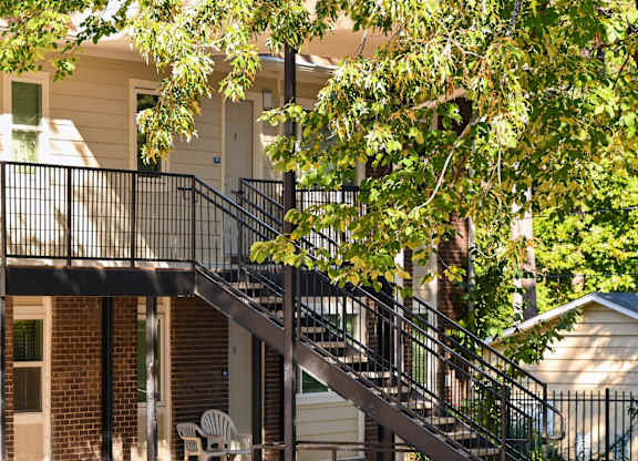 A Tree Branch is Hanging Over a Metal Railing on a Staircase at Fair Oaks Apartments, Little Rock, AR, 72204